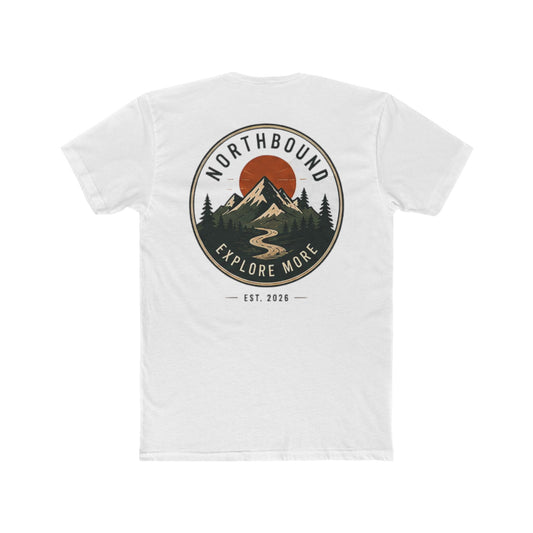 A white short-sleeve t-shirt with a circular graphic on the chest depicting a mountain, pine trees, a winding river, and a red sun, with the text 'NORTHBOUND' and 'EXPLORE MORE' and 'EST. 2026'.