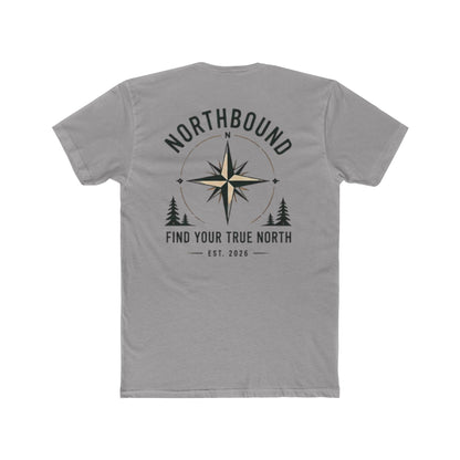 A gray short-sleeve t-shirt shown from the back, featuring a dark gray graphic print with a compass rose, pine trees, and the text 'NORTHBOUND' and 'FIND YOUR TRUE NORTH EST. 2026'.