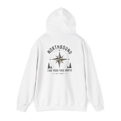 A white pullover hoodie shown from the back, featuring a black graphic print with a compass rose, pine trees, and the text 'NORTHBOUND' and 'FIND YOUR TRUE NORTH EST. 2026'.